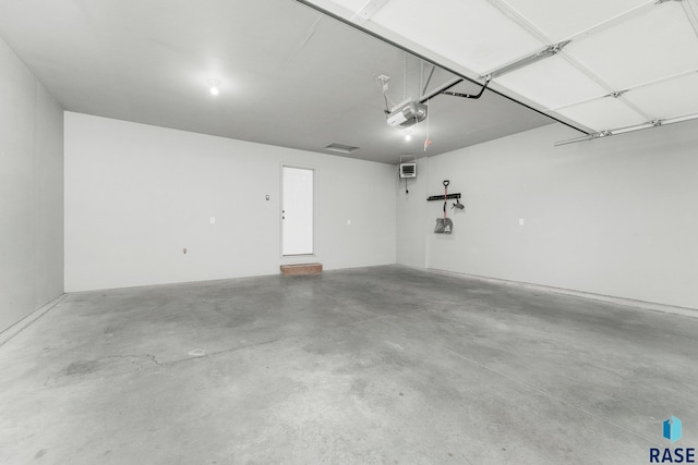 204 E 81st Pl, Sioux Falls, SD 57108 - garage with a wall mounted air conditioner and a garage door opener