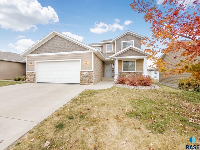 204 E 81st Pl, Sioux Falls, SD 57108 - craftsman inspired home with stone siding, driveway, a front lawn, and a garage