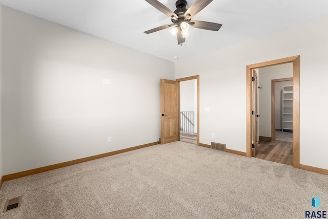 unfurnished bedroom featuring carpet, visible vents, and baseboards
