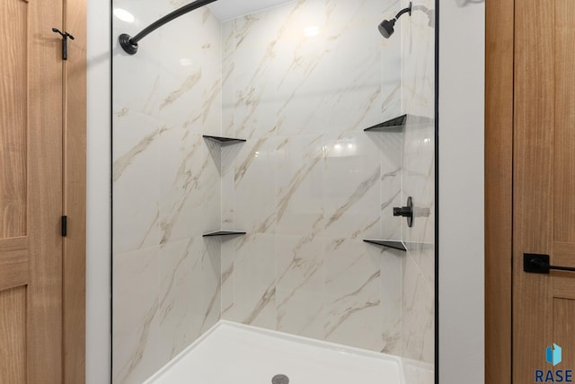 bathroom with a marble finish shower