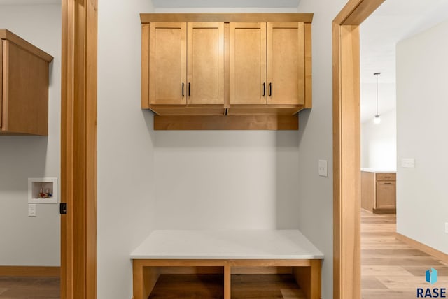 mudroom with baseboards and light wood-style floors