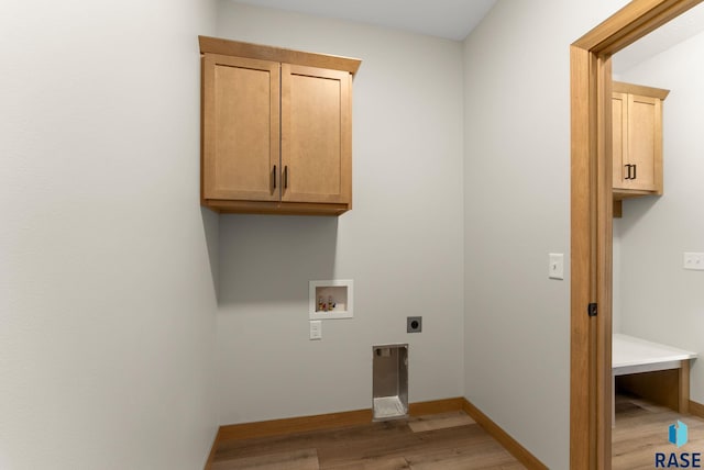 clothes washing area with baseboards, light wood-type flooring, hookup for a washing machine, cabinet space, and electric dryer hookup