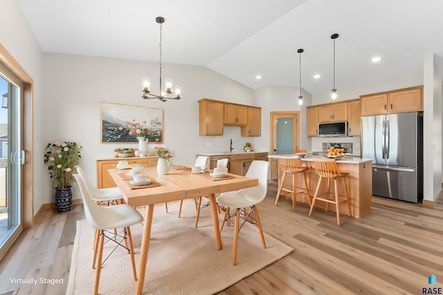 dining room featuring light wood finished floors, a notable chandelier, recessed lighting, and lofted ceiling