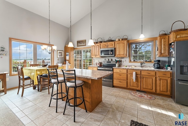 6305 Lakeview Dr, Wentworth, SD 57075 - kitchen with a sink, a notable chandelier, a wealth of natural light, and stainless steel appliances