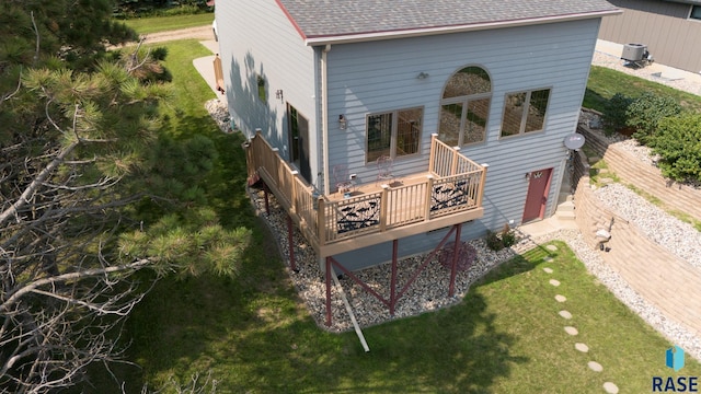 6305 Lakeview Dr, Wentworth, SD 57075 - rear view of property featuring a wooden deck, a yard, central AC, and a shingled roof