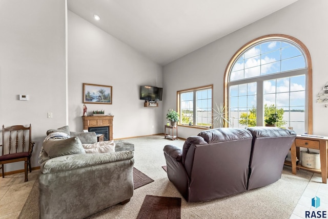 6305 Lakeview Dr, Wentworth, SD 57075 - living room featuring a glass covered fireplace, baseboards, and high vaulted ceiling