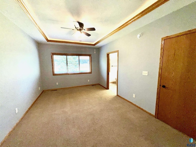 800 W Sterling Oak Cir, Sioux Falls, SD 57108 - spare room with a tray ceiling, a ceiling fan, and light colored carpet