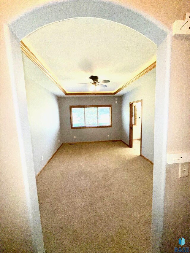 800 W Sterling Oak Cir, Sioux Falls, SD 57108 - carpeted empty room featuring a ceiling fan, a tray ceiling, and ornamental molding