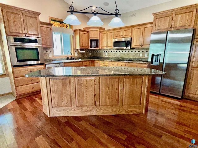 800 W Sterling Oak Cir, Sioux Falls, SD 57108 - kitchen featuring stainless steel appliances, dark wood-style floors, decorative backsplash, a kitchen island, and lofted ceiling