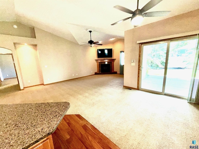 800 W Sterling Oak Cir, Sioux Falls, SD 57108 - unfurnished living room with lofted ceiling, ceiling fan, and a fireplace with raised hearth
