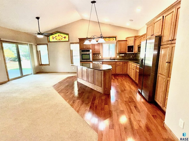 800 W Sterling Oak Cir, Sioux Falls, SD 57108 - kitchen with stainless steel appliances, high vaulted ceiling, ceiling fan, decorative light fixtures, and a kitchen island
