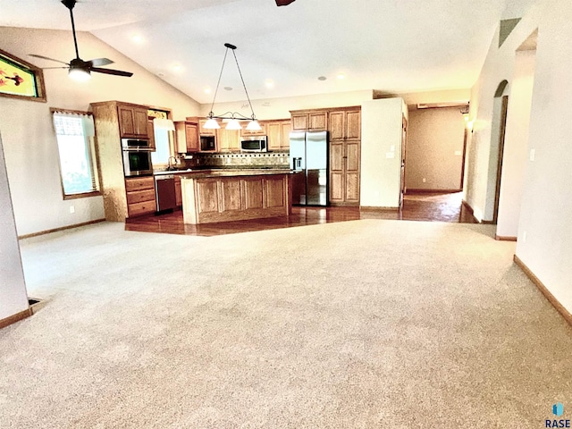 800 W Sterling Oak Cir, Sioux Falls, SD 57108 - kitchen with stainless steel appliances, open floor plan, ceiling fan, tasteful backsplash, and dark colored carpet