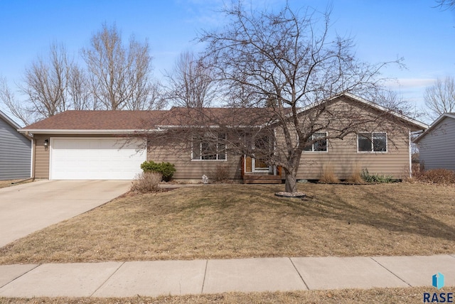ranch-style home featuring a front yard, concrete driveway, and a garage