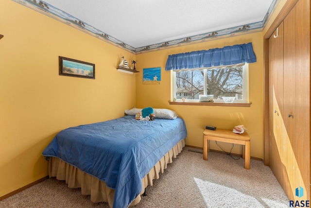 bedroom featuring baseboards and carpet floors