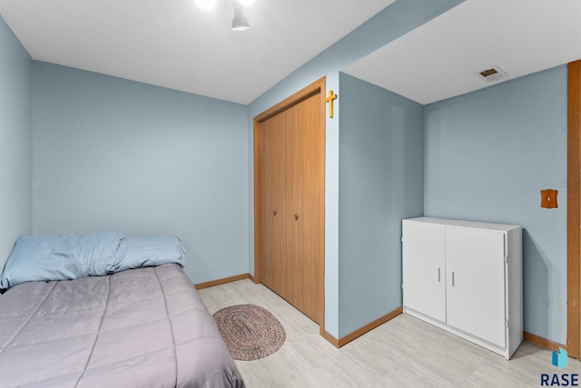 bedroom featuring visible vents, baseboards, and light floors