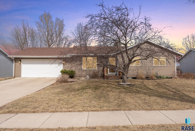 ranch-style house with a front yard, a garage, and driveway