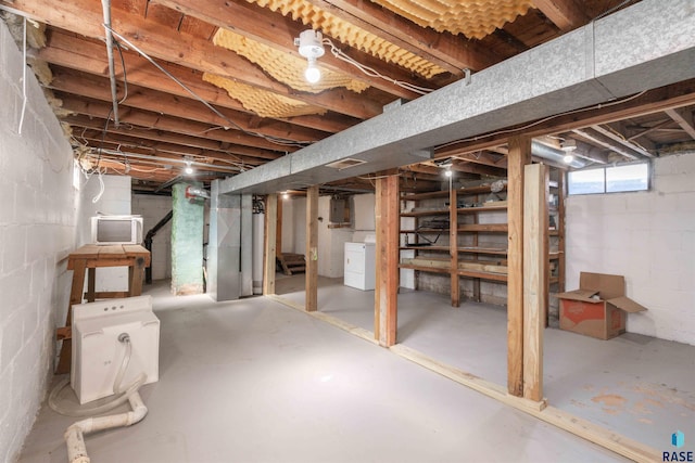 below grade area with electric panel, stairway, and washer / clothes dryer