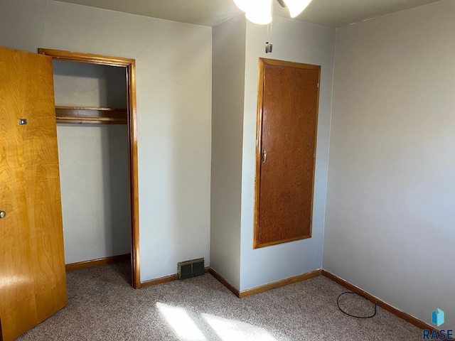 unfurnished bedroom featuring baseboards, a closet, and carpet floors
