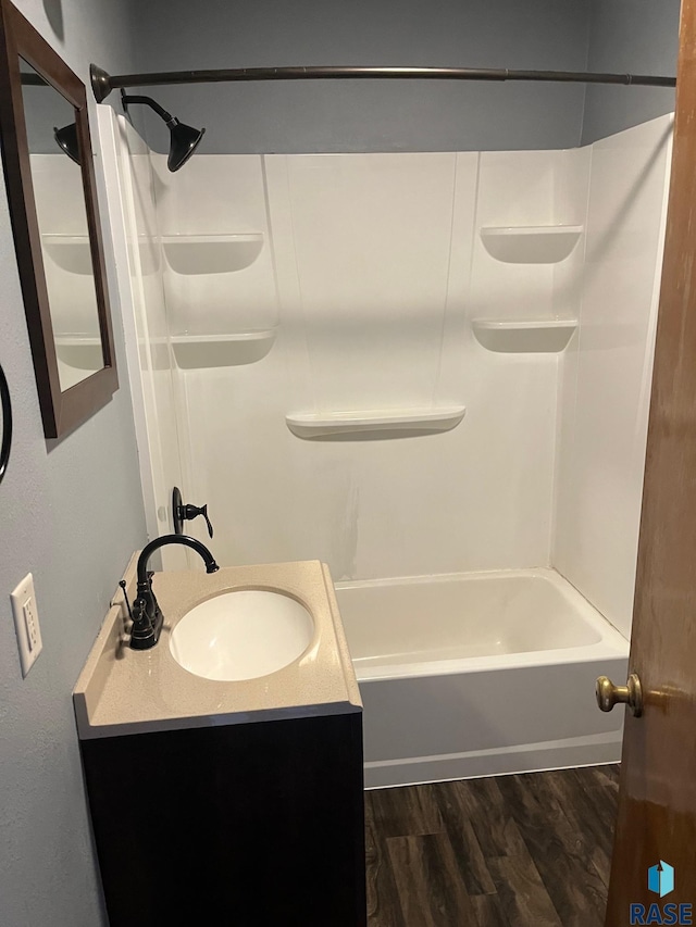 bathroom with shower / washtub combination, vanity, and wood finished floors