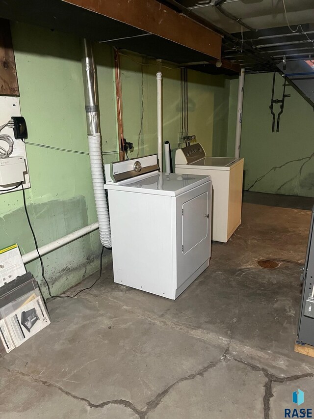 unfinished basement featuring independent washer and dryer