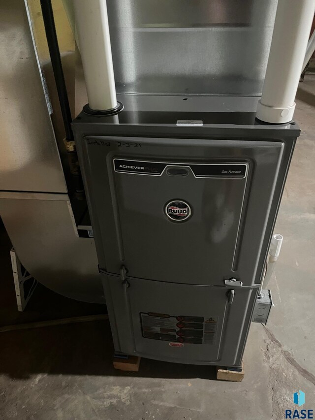 utility room featuring heating unit