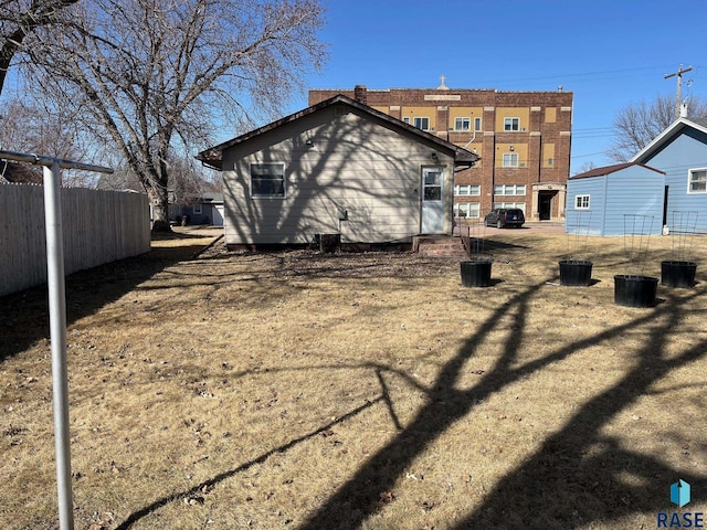 rear view of property with fence