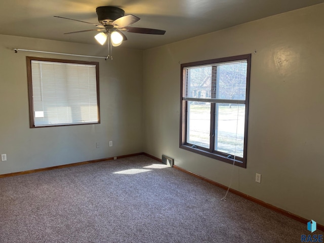 unfurnished room with baseboards, a ceiling fan, and carpet floors