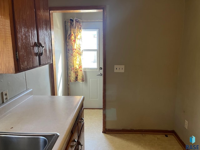 kitchen featuring light countertops and baseboards