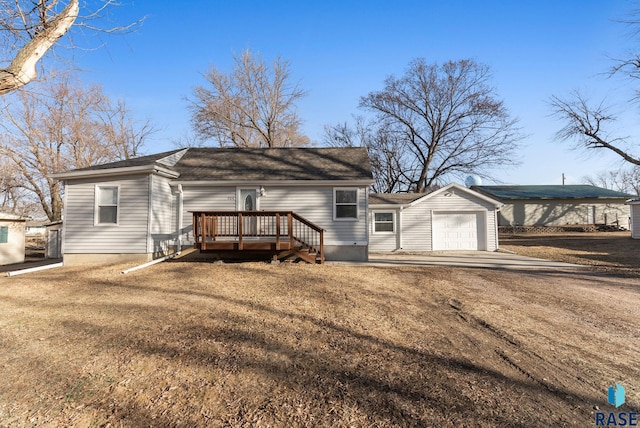 view of front of house featuring a wooden deck, an attached garage, and a shingled roof