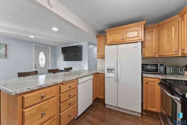 kitchen with a textured ceiling, a peninsula, dark wood-style flooring, and stainless steel appliances