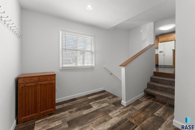 stairs with recessed lighting, baseboards, and wood finished floors