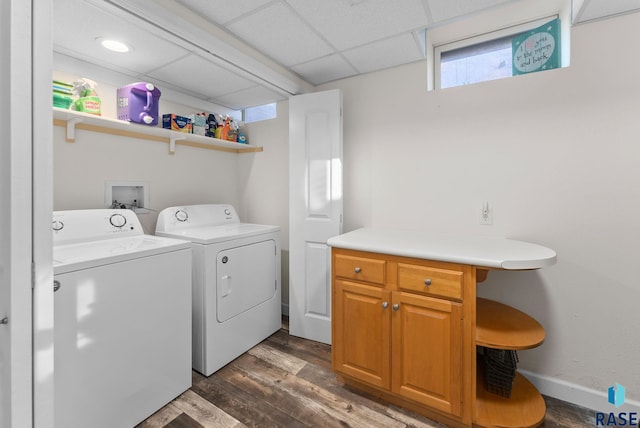 laundry area featuring washer and clothes dryer, dark wood-style floors, and baseboards
