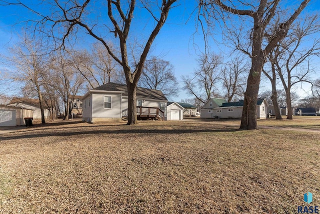 view of front of house featuring an outdoor structure, a front lawn, and a detached garage