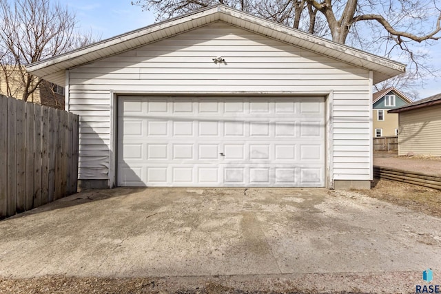detached garage featuring fence