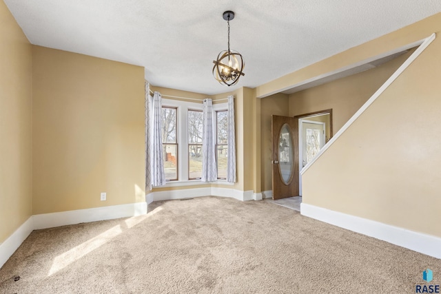 carpeted entrance foyer with baseboards, a textured ceiling, visible vents, and an inviting chandelier