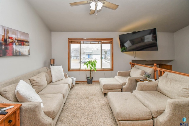 carpeted living room with baseboards and a ceiling fan