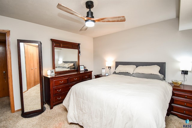 bedroom with a ceiling fan and light carpet