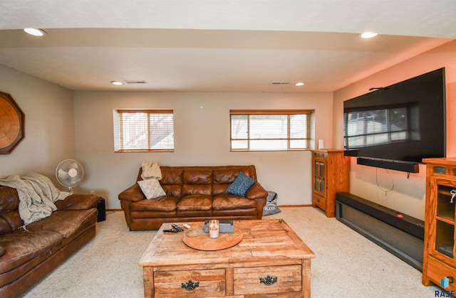 carpeted living area with a wealth of natural light, visible vents, and recessed lighting