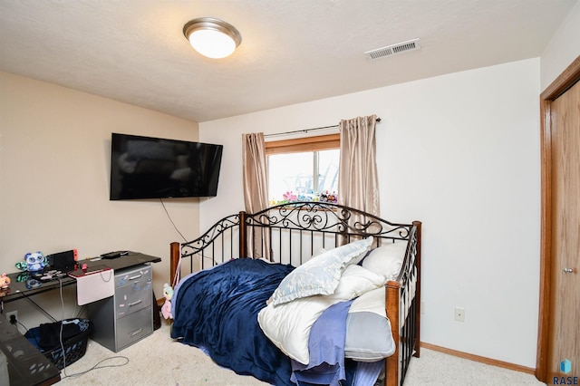 carpeted bedroom with baseboards and visible vents
