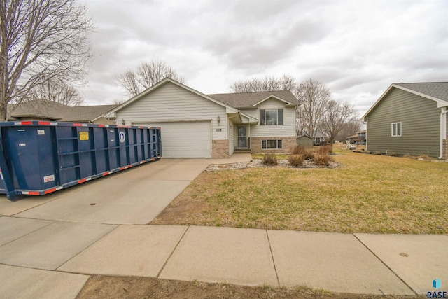 view of front of house with a front lawn, an attached garage, brick siding, and concrete driveway