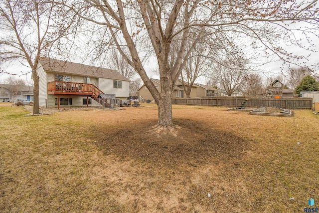 view of yard featuring stairs, fence, and a deck