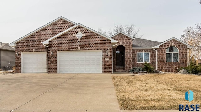 7329 S Russet Dr, Sioux Falls, SD 57108 - single story home with brick siding, a garage, concrete driveway, and a front yard
