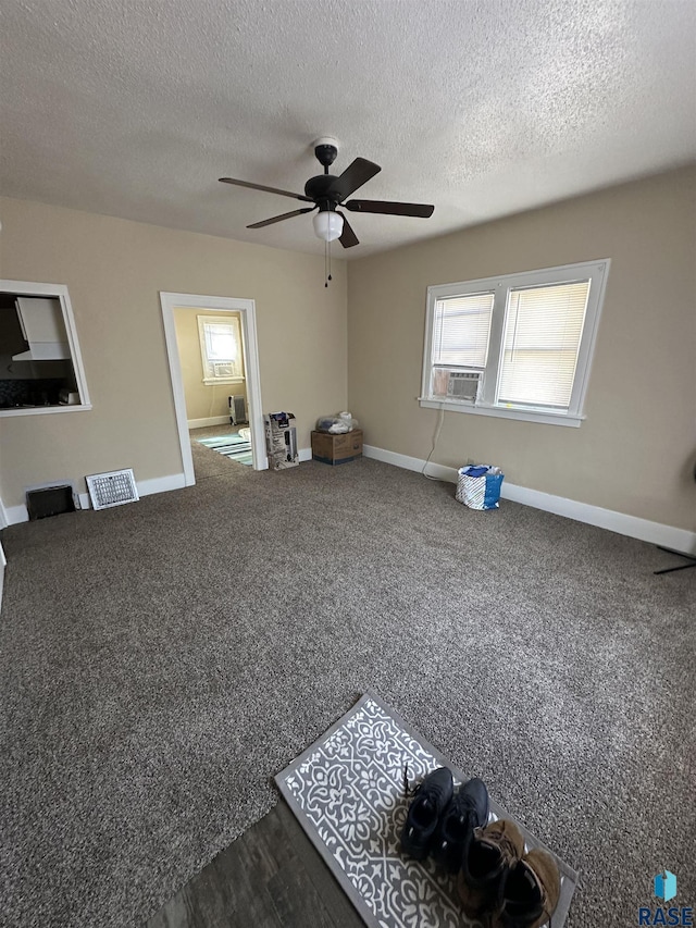 unfurnished room featuring baseboards, visible vents, a healthy amount of sunlight, and a ceiling fan