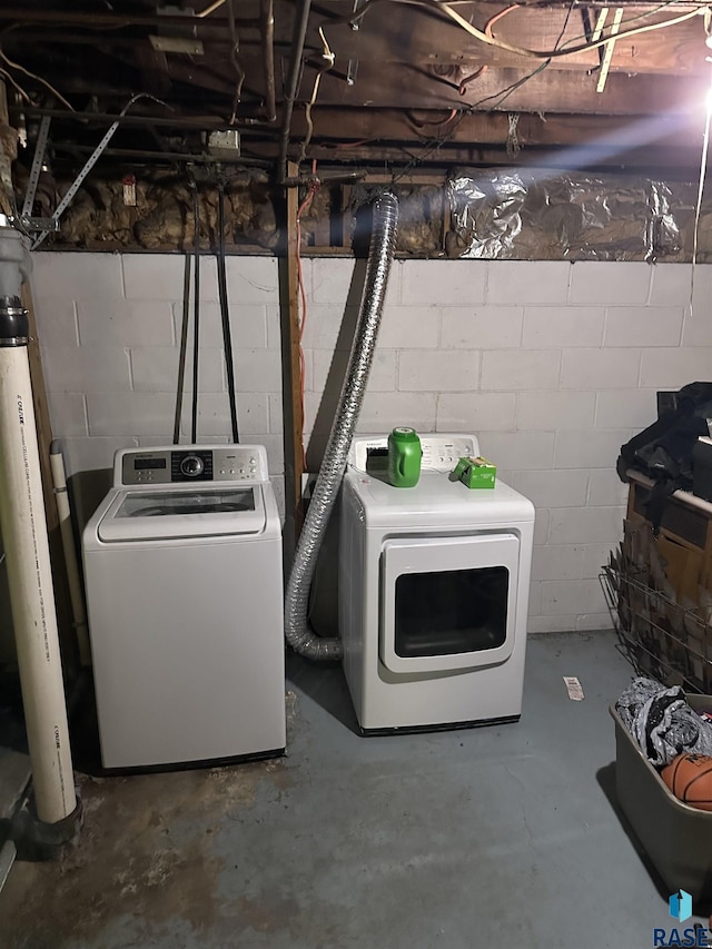 clothes washing area featuring independent washer and dryer and laundry area