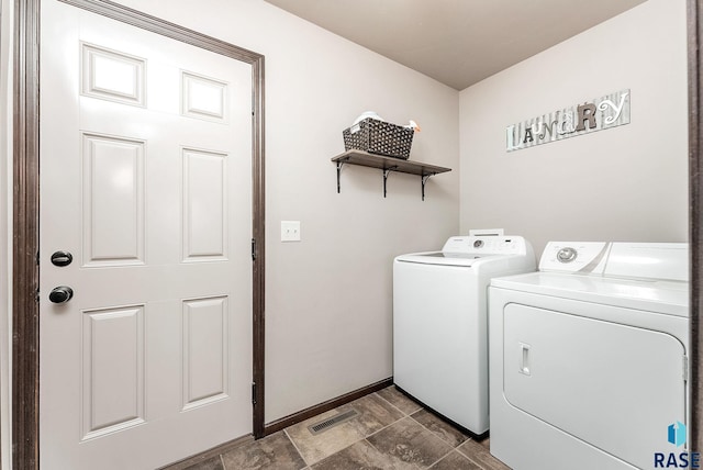 laundry area with washing machine and dryer, visible vents, and laundry area