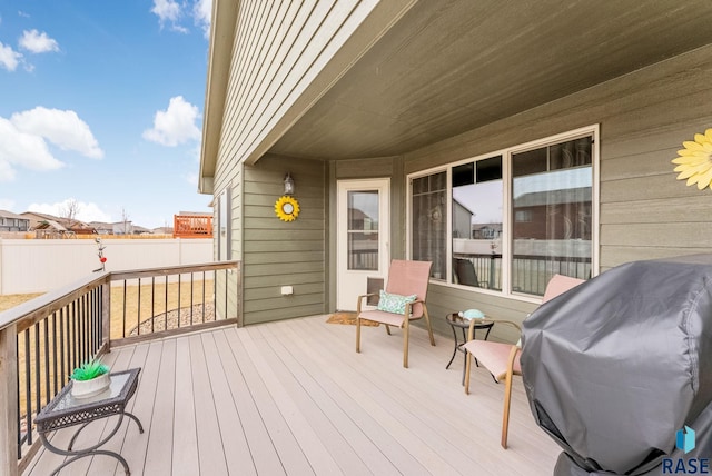 wooden deck featuring fence and area for grilling