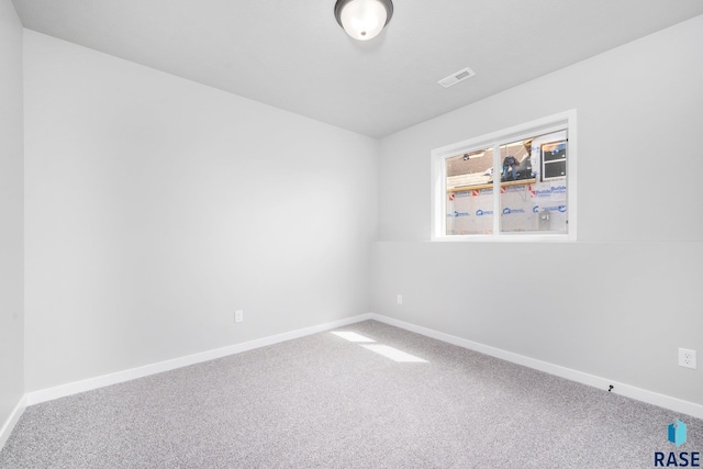 unfurnished room with baseboards, carpet floors, and visible vents
