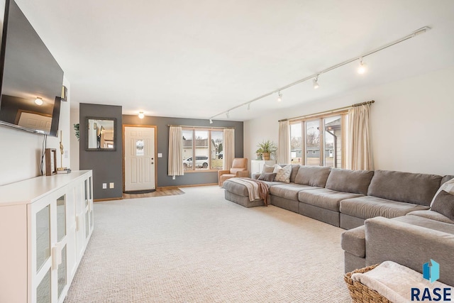 living room featuring track lighting and light colored carpet