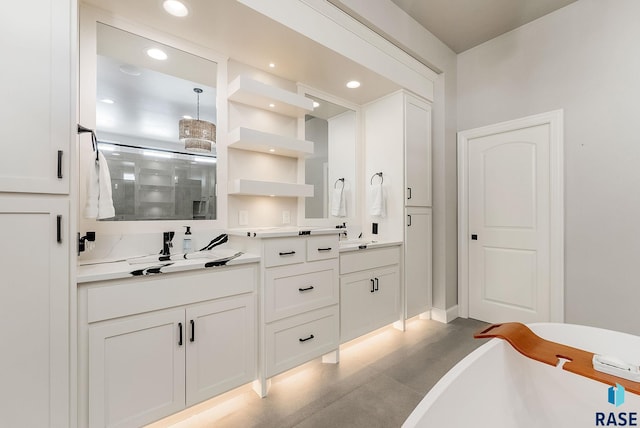 bathroom featuring double vanity, recessed lighting, a stall shower, and a soaking tub