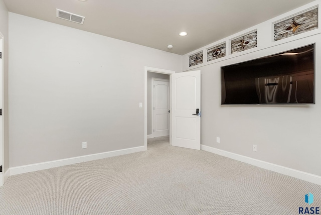 unfurnished room featuring recessed lighting, carpet, baseboards, and visible vents